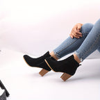 Liv black block heel ankle boots worn, seated view