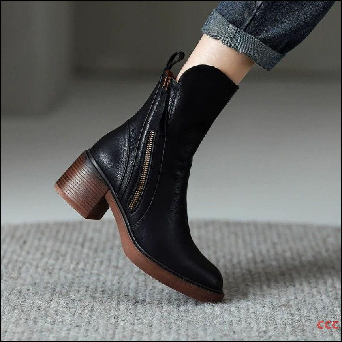 Edith black ankle boot worn with cropped jeans, showing the rounded toe and stacked block heel – Black