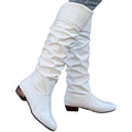 Alva white ruched flat knee-high boots worn with jeans