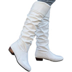 Alva white ruched flat knee-high boots worn with jeans