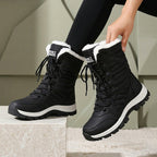 Freya black snow boots with faux-fur collar, worn
