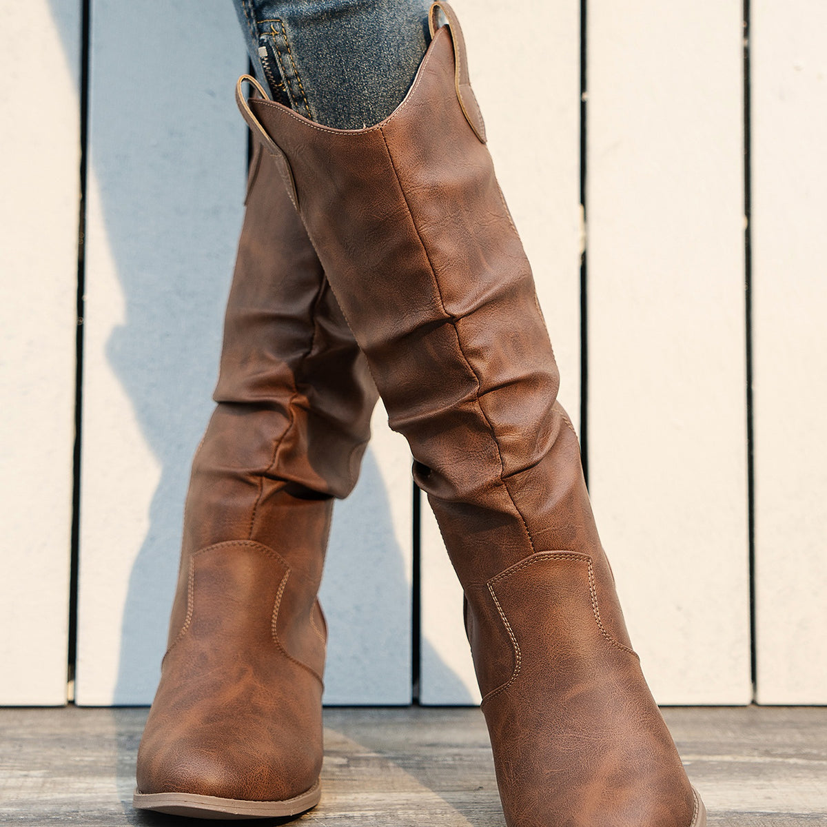 Clemency brown cowboy boots worn, front view of the slouch shaft