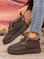Embla brown quilted snow boots worn with jeans