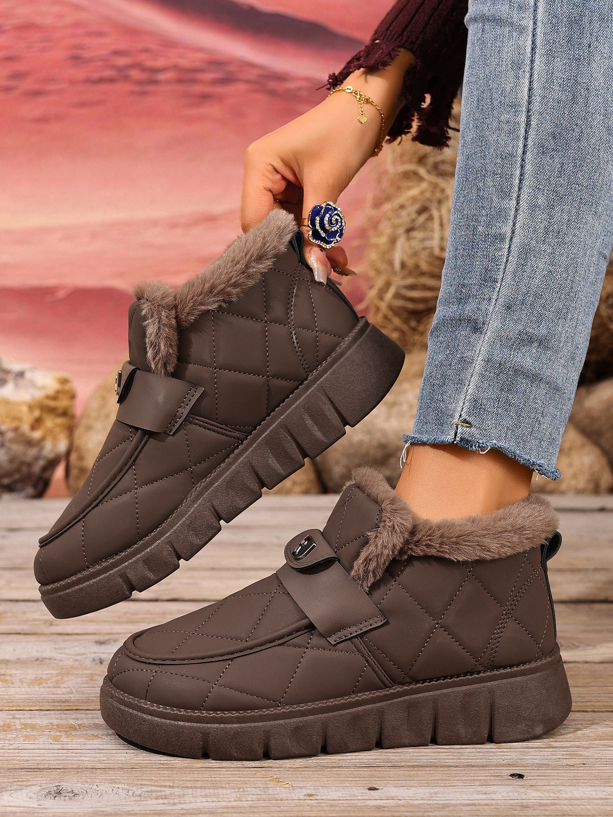 Embla brown quilted snow boots worn with jeans