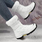 Linnea white snow boots worn, showing the chunky lug sole