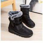 Ronja black snow boots with hook-and-loop strap, worn