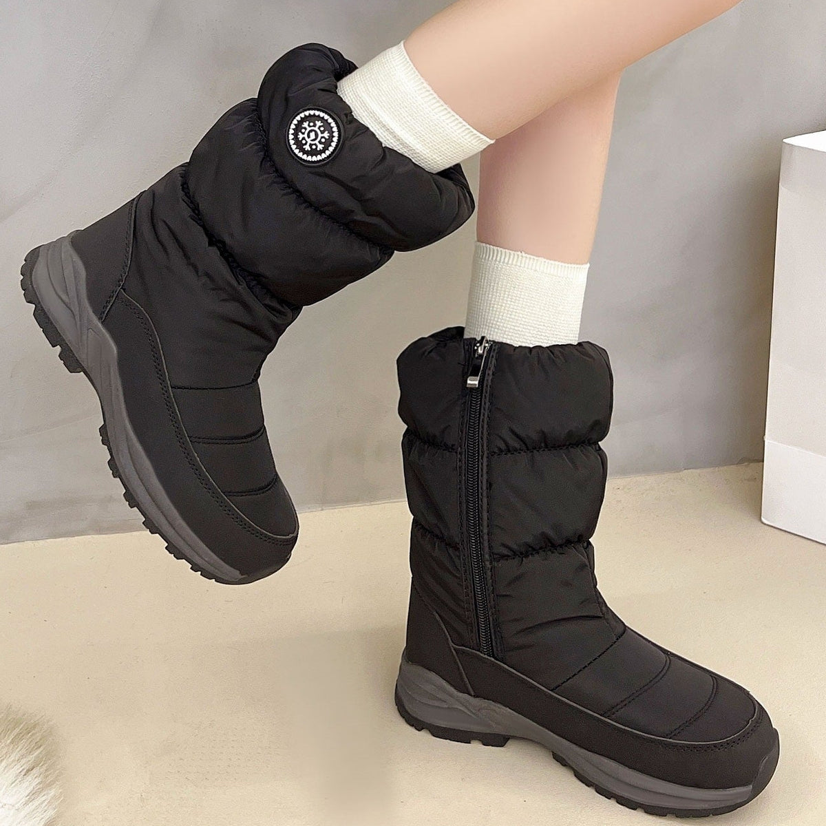 Sigrid black puffer snow boots worn, side zip view