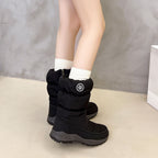 Sigrid black puffer snow boots worn with socks