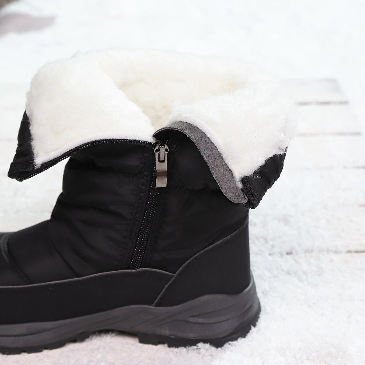 Sigrid black snow boots showing the plush lining and side zip