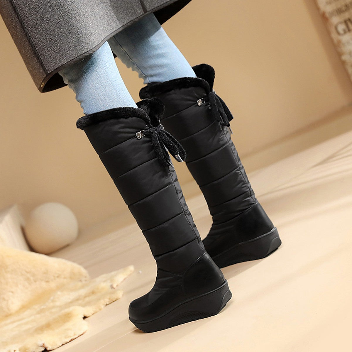 Solveig black puffer boots worn, showing the back ties