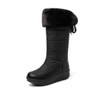 Solveig black snow boot with the faux-fur cuff folded down