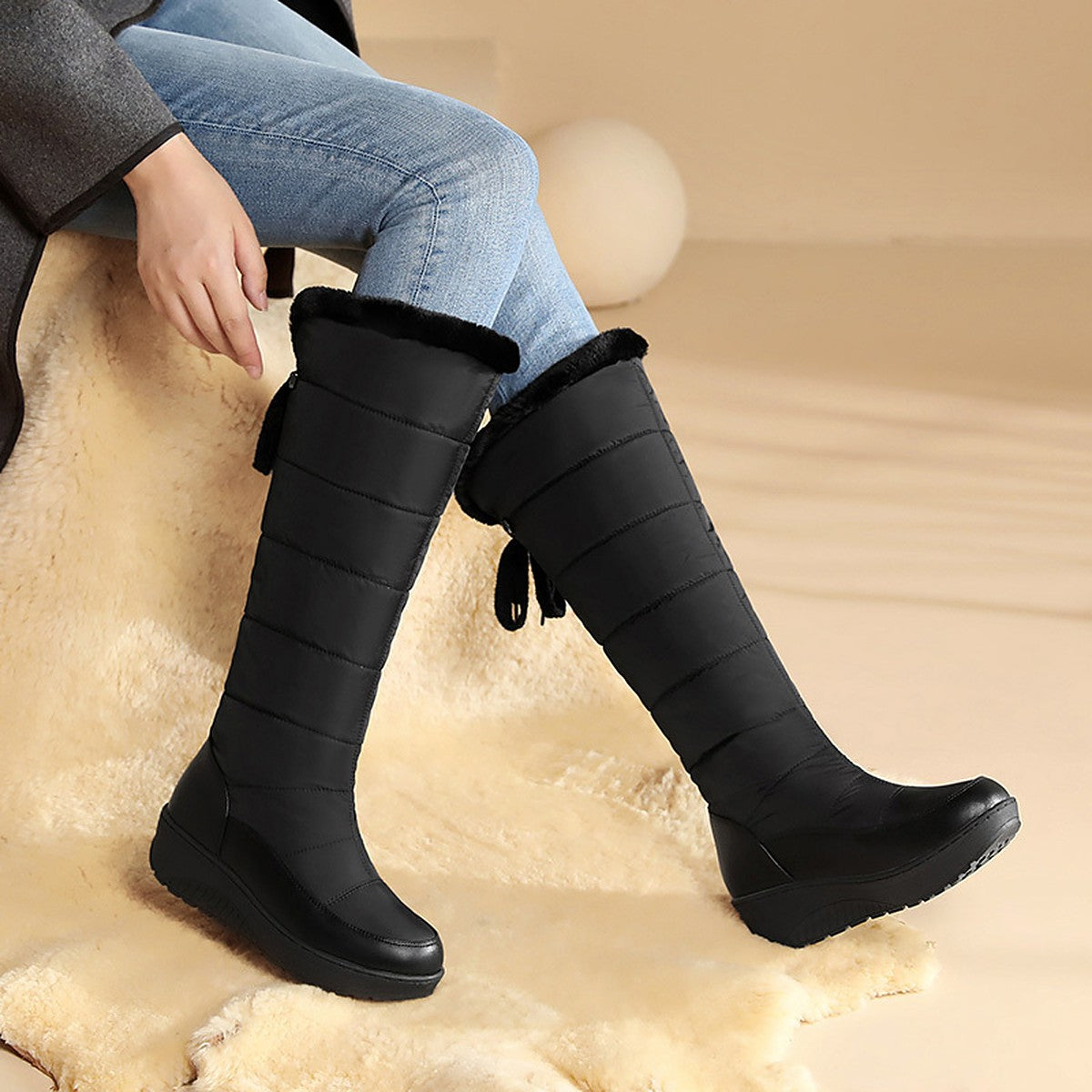 Solveig black snow boots worn with jeans