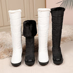 Solveig snow boots in White and Black, cuffs up and folded down