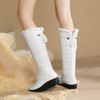 Solveig white puffer boots worn, showing the back ties