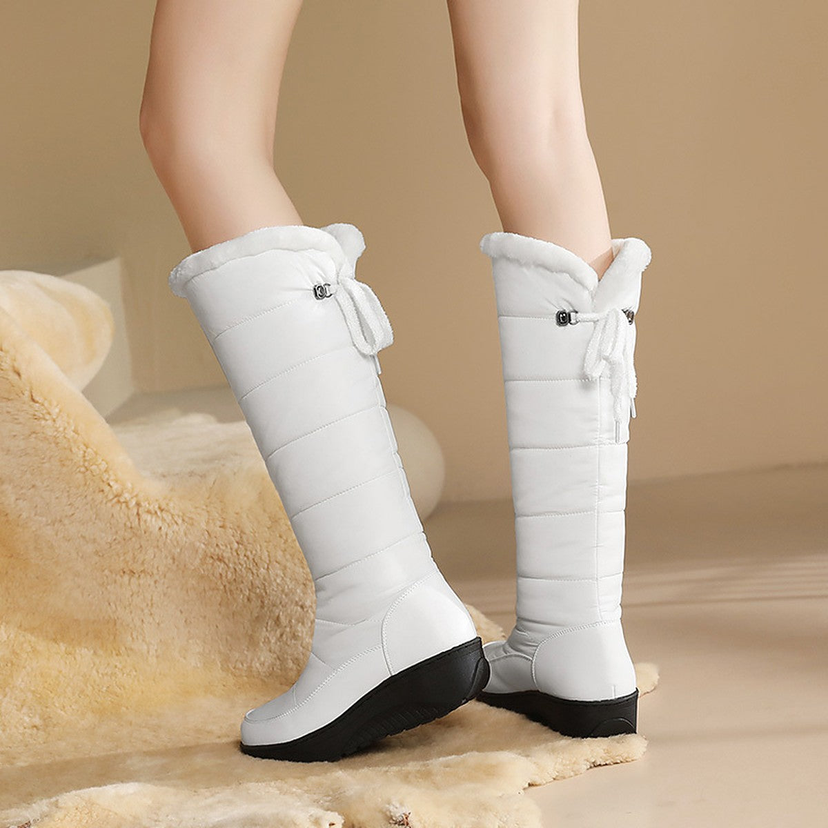 Solveig white puffer boots worn, showing the back ties