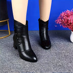 Thessaly black heeled ankle boots worn, front view of the pointed toe