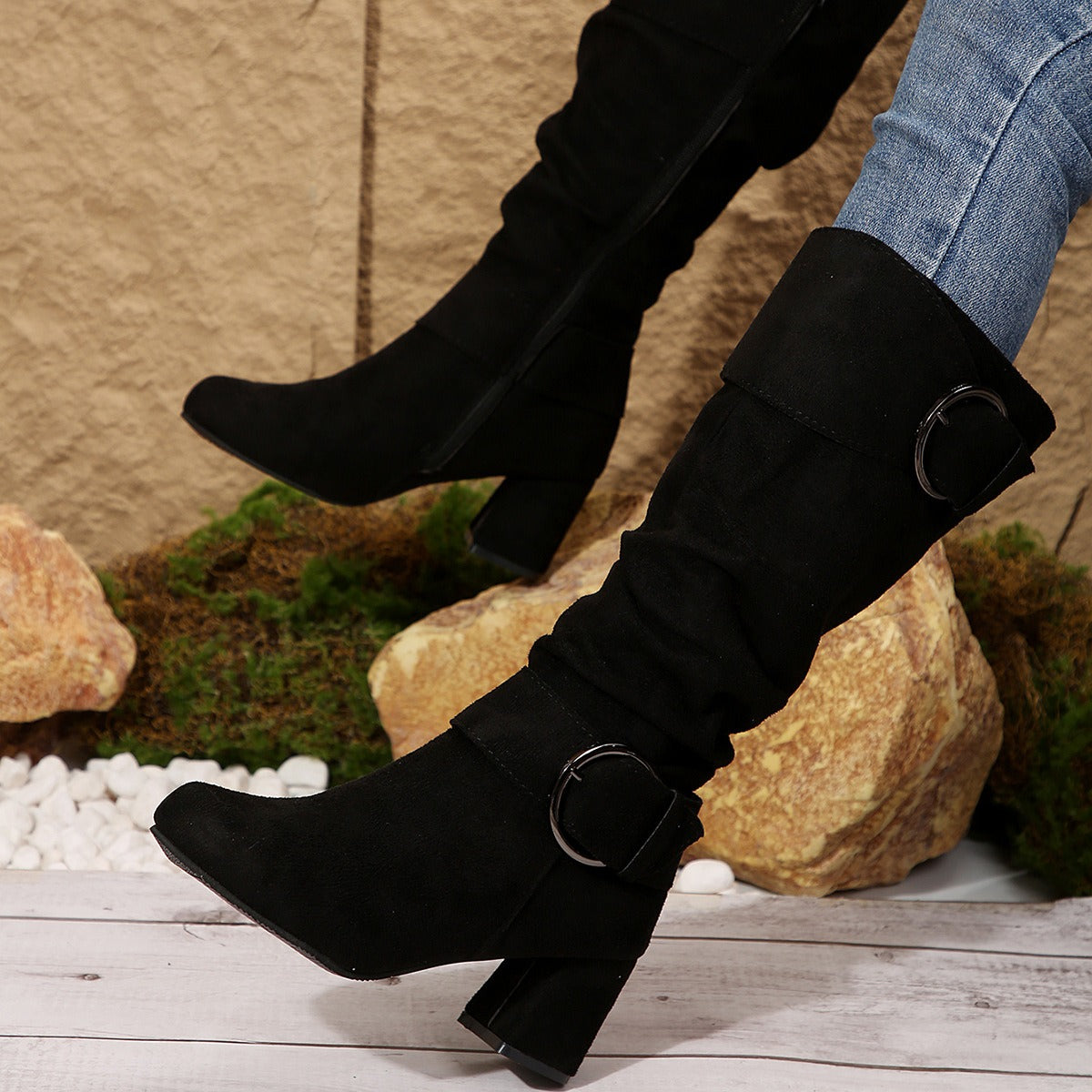 Tyra black slouch boots worn, ring buckles at top and ankle