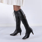 Vigdis black lace-up knee-high boots worn with a white skirt