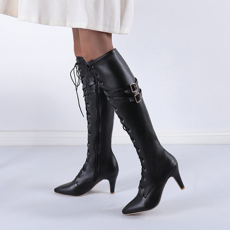Vigdis black lace-up knee-high boots worn with a white skirt