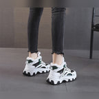 Ylva black and green trainers worn, back view