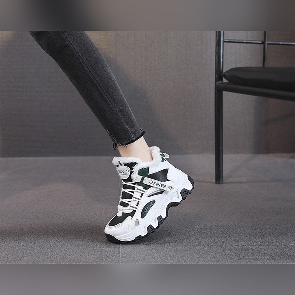 Ylva black and green trainers worn, side view