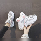 Ylva grey and pink chunky trainers held in hand